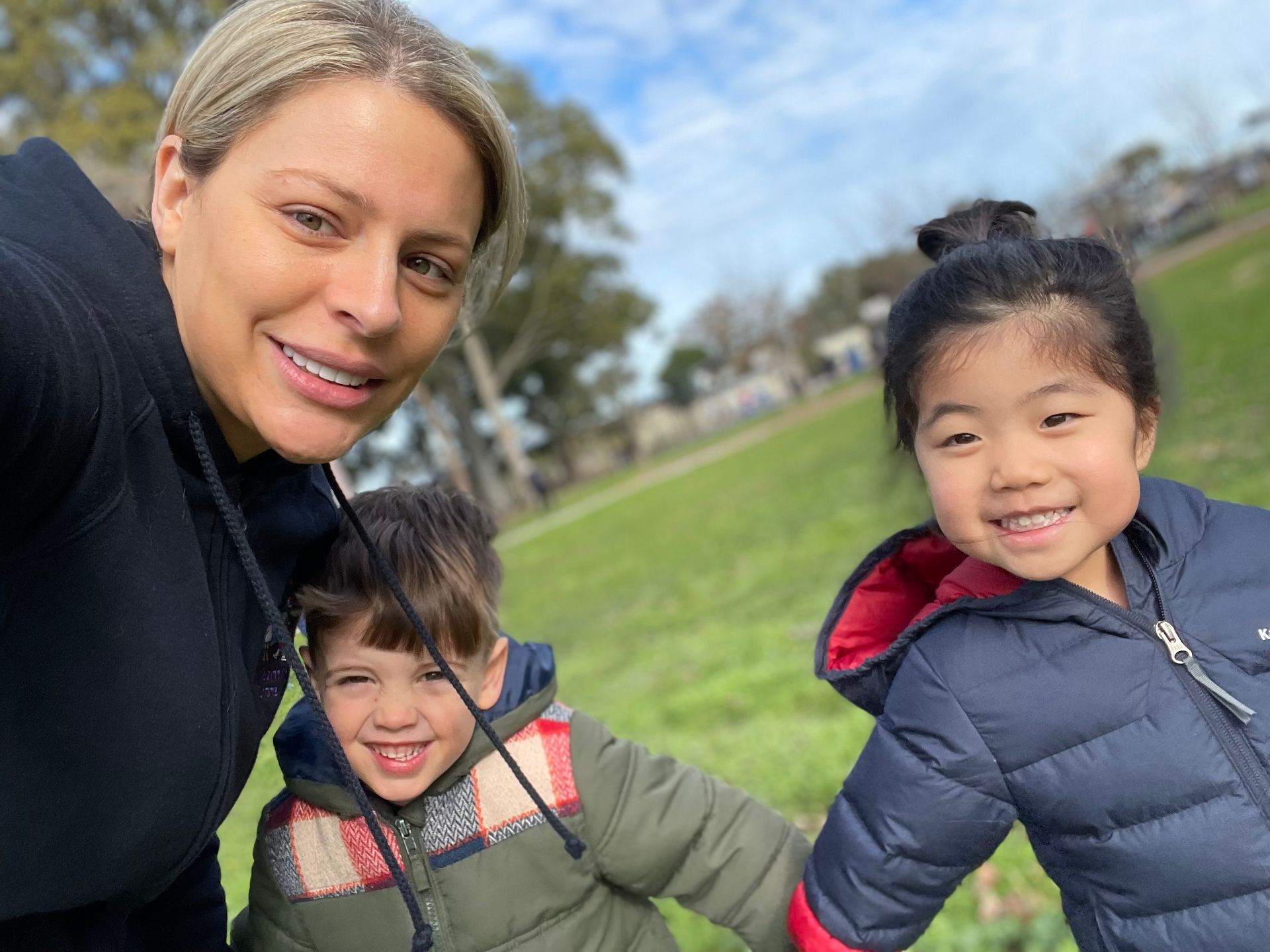 An educator and children enjoying time outdoors