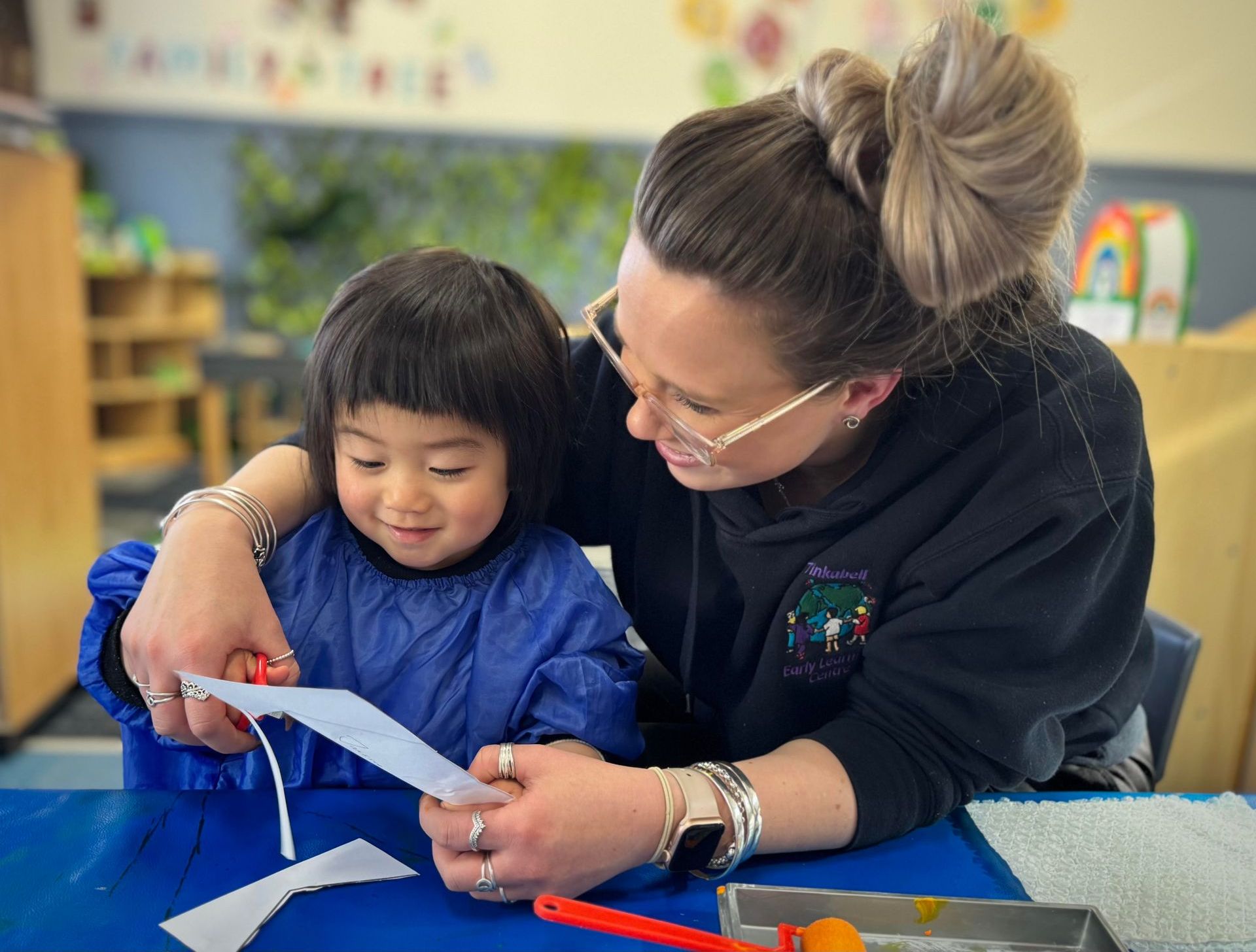 An educator sharing a learning moment with a child